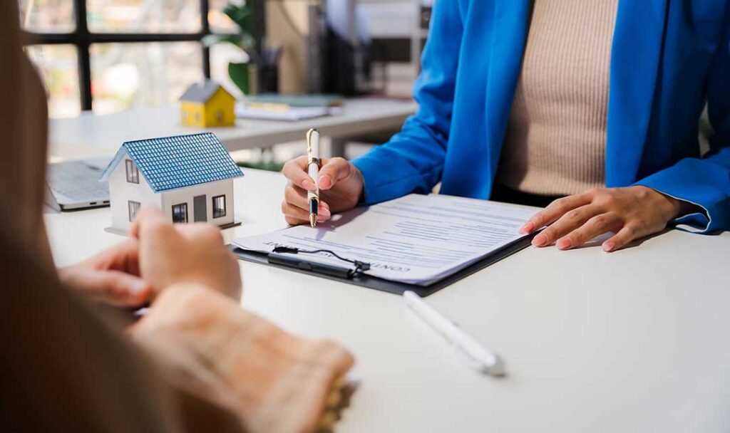 A homeowner reviews an insurance bill and cancellation notice beside a calendar and calculator.
